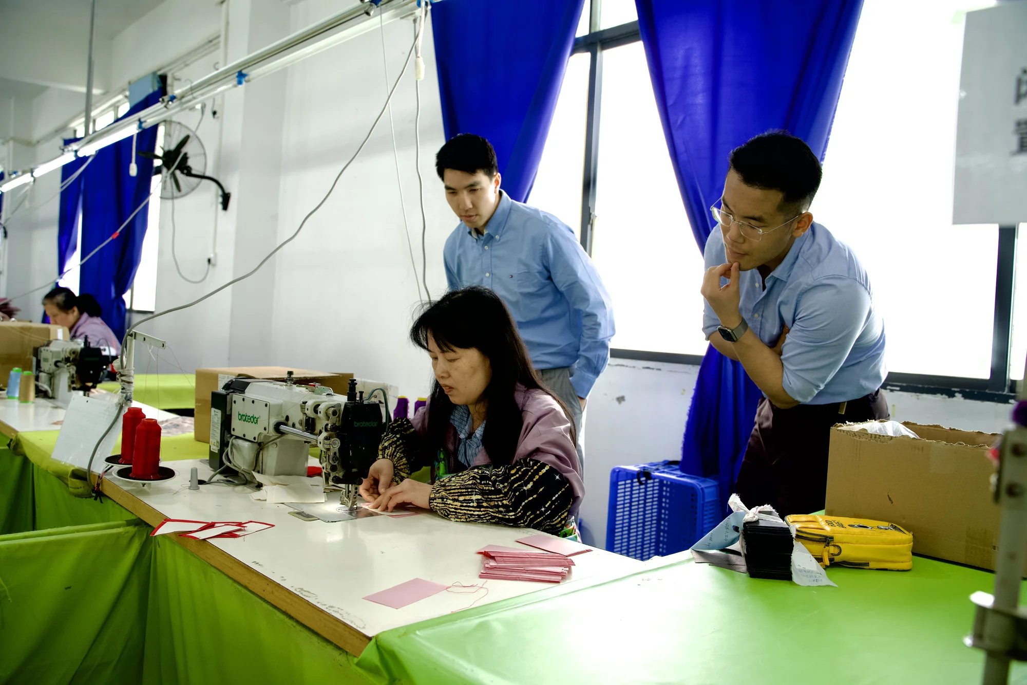 Workshop visit and discussion beside a bag sewing station
